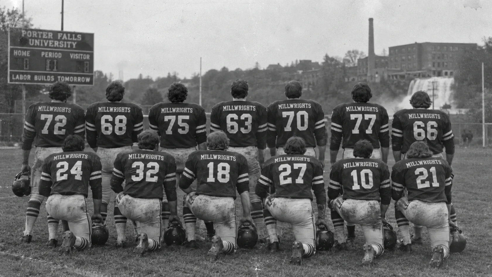 A black-and-white photo of the Porter Millwrights football team, shown from behind.