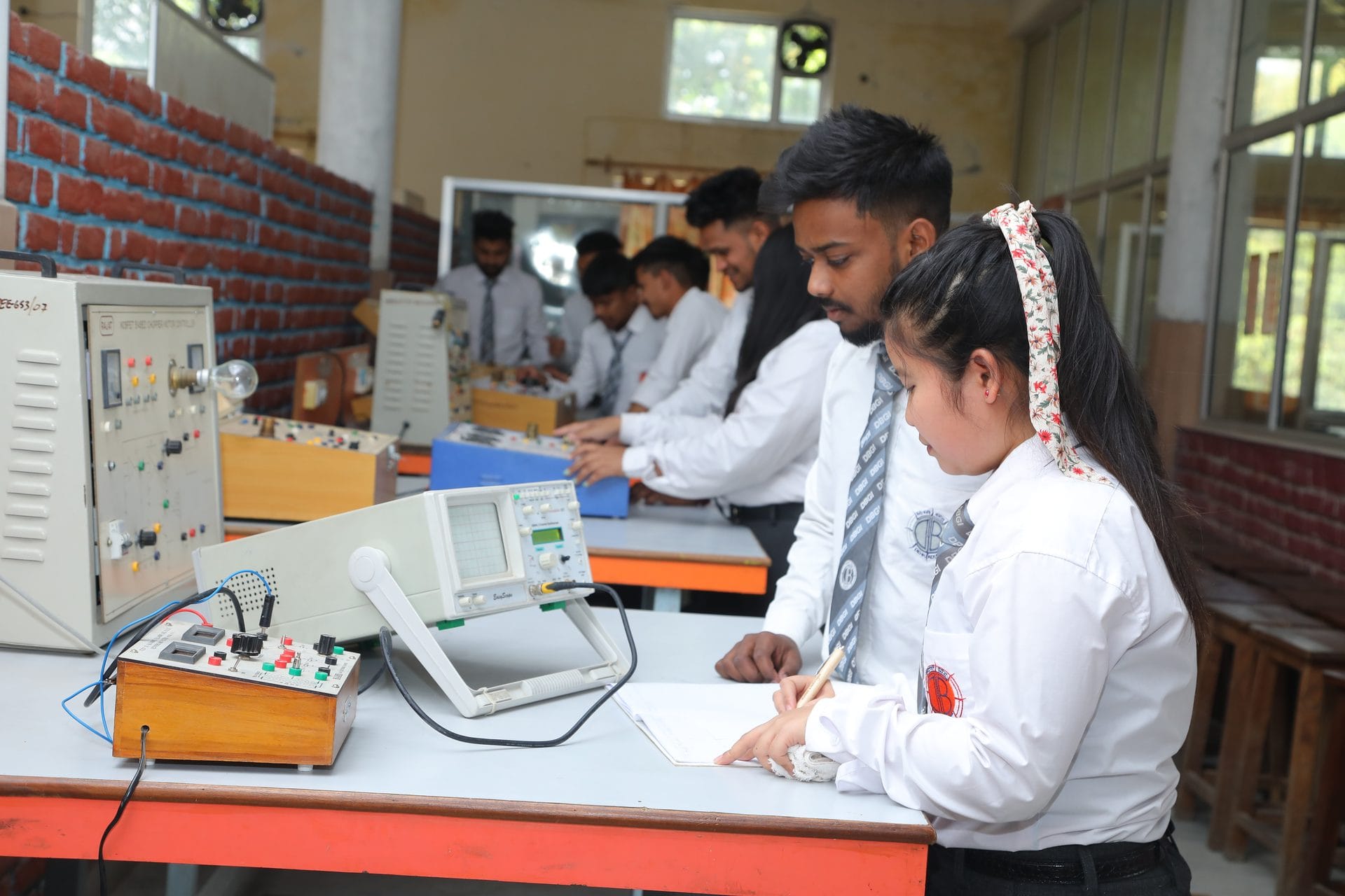 mechanical engineering program — Engineering students working with lab instrumentation at a bench.