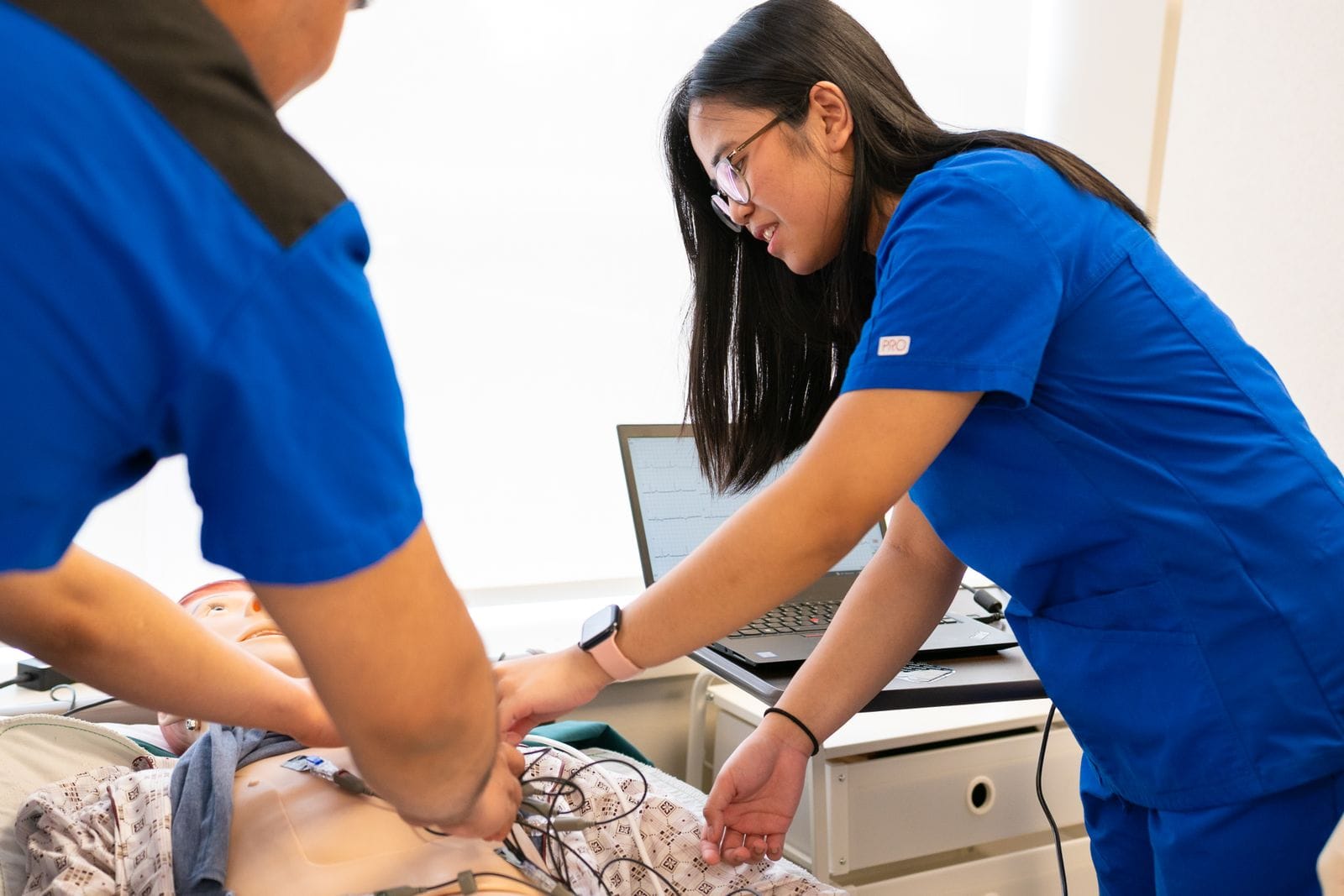 nursing program — Nursing students practicing patient care in a simulation lab.