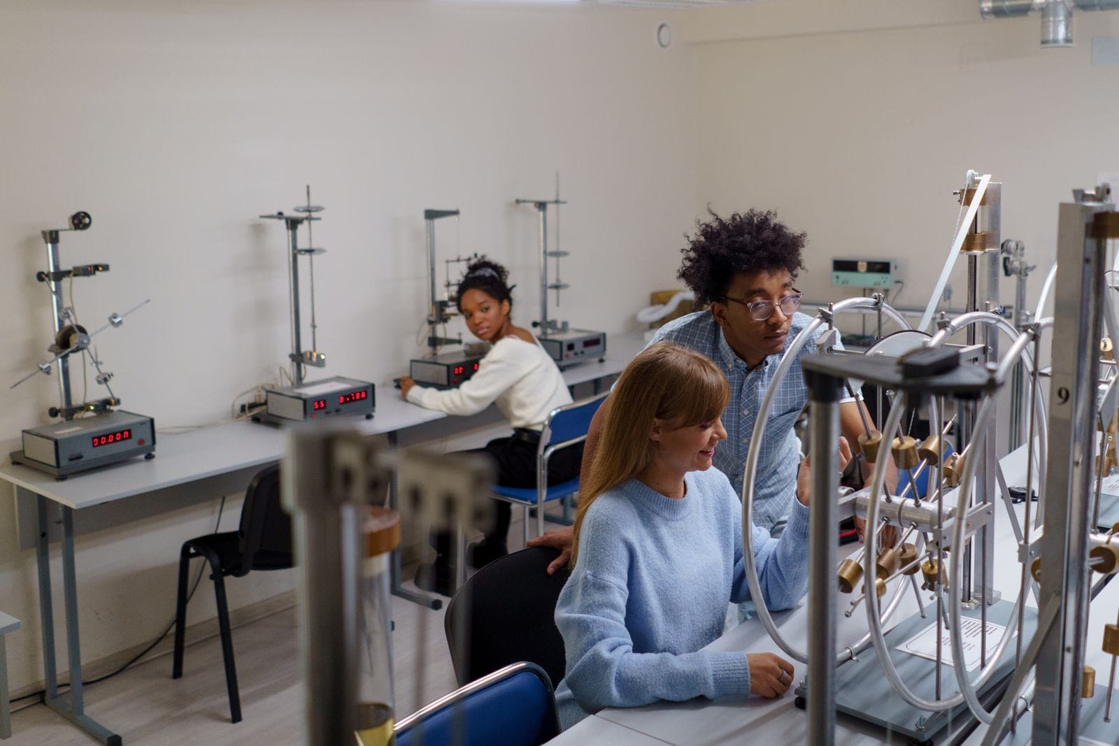 Students testing equipment together in a science laboratory.